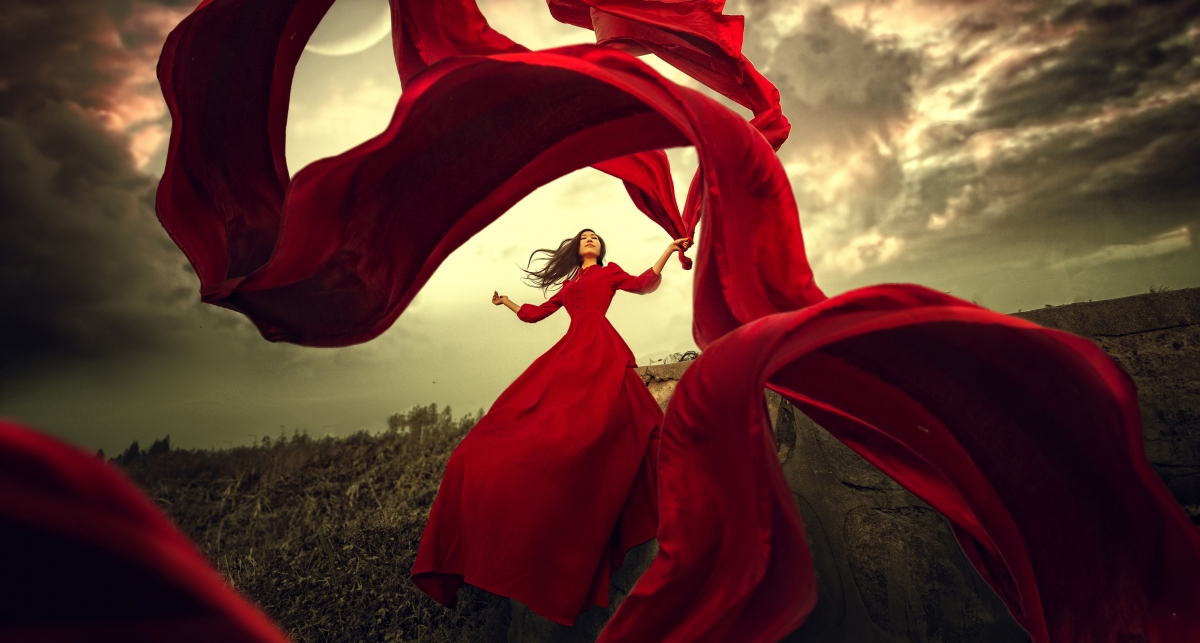 穿红色礼服裙子的美女红色彩带摄影图片